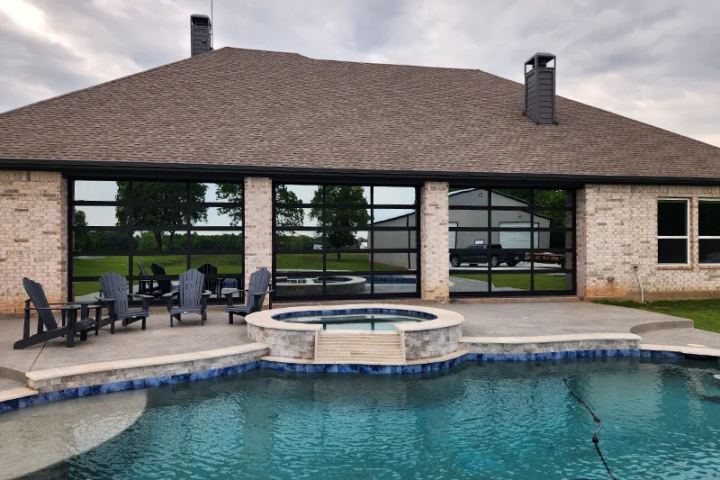 Texas Garage Door - black anodized frame with ¼” bronze mirrorpane tempered glass
